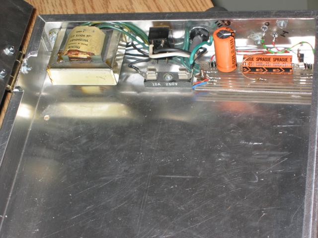 Small PCB containing the power supply mounted in the audio/video switch project box case